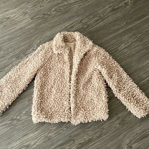 Shrug jacket, it is called “shell” color. It is a dusty pink color.